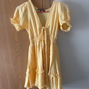 Yellow tie front dress with ruffle bottom